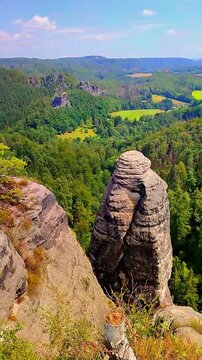 View over monumental Bastei sandstone pillars and ancient bridge near Kurort Rathen village in the national park Saxon Switzerland by Dresden, Saxony, Germany.