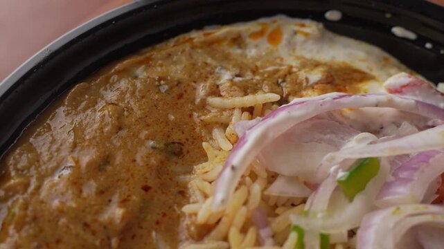 Aromatic Spiced Masala Rice Served with Rich Indian Curry and Fresh Sliced Onion Topping in a Bowl, Close-Up Food Shot.