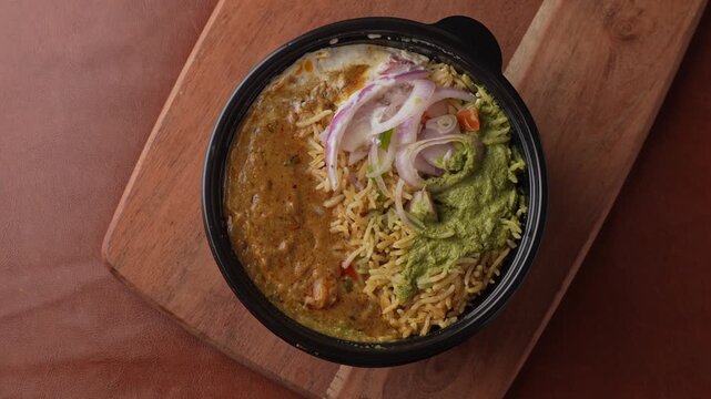 Aromatic Spiced Masala Rice Served with Rich Indian Curry and Fresh Sliced Onion Topping in a Bowl, Close-Up Food Shot.