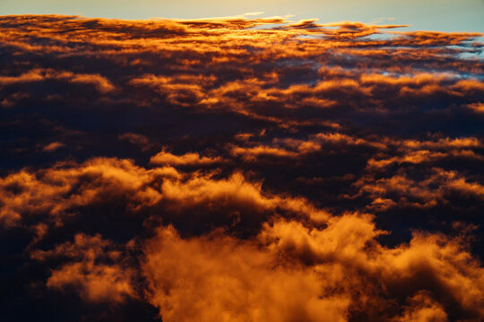 Golden clouds at sunset over the horizon