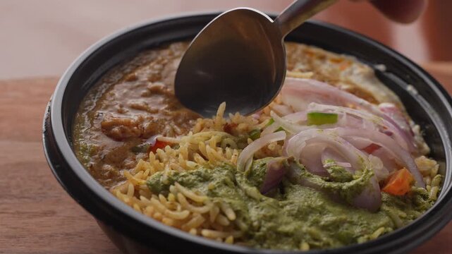 Aromatic Spiced Masala Rice Served with Rich Indian Curry and Fresh Sliced Onion Topping in a Bowl, Close-Up Food Shot.