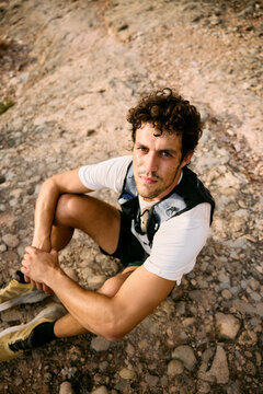 Trail Runner Resting on Rocky Path