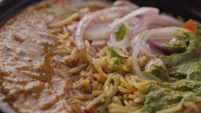 Aromatic Spiced Masala Rice Served with Rich Indian Curry and Fresh Sliced Onion Topping in a Bowl, Close-Up Food Shot.