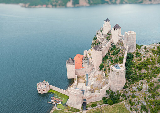 Aerial view centering Golubac Fortress towers rising from rocky cliffs above the Danube River