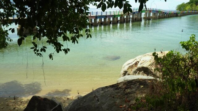 Rocky Tropical Beach With Wooden Pier