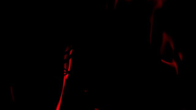 Abstract red flames and fire against a dark black background, creating a dramatic and intense fiery texture