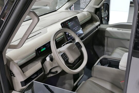 Interior with driving wheel, dashboard and front seats in modern korean  battery electric full-size van and PBV (purpose built vehicle) KIA PV7 Passenger Long, displayed on Car Expo in Nitra, Slovakia