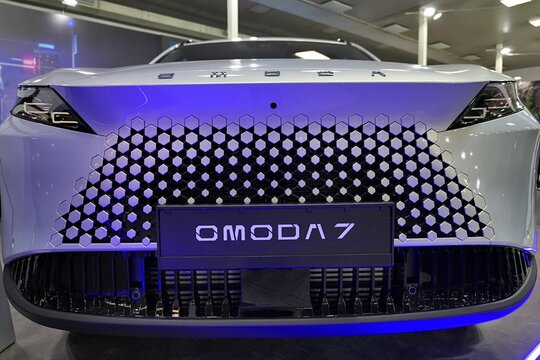 Impressive stylish blue LED backlit front mask of Omoda C7, modern chinese compact crossover SUV car by Chery automobile, displayed on Car Expo in Nitra, Slovakia, october 2026. 
