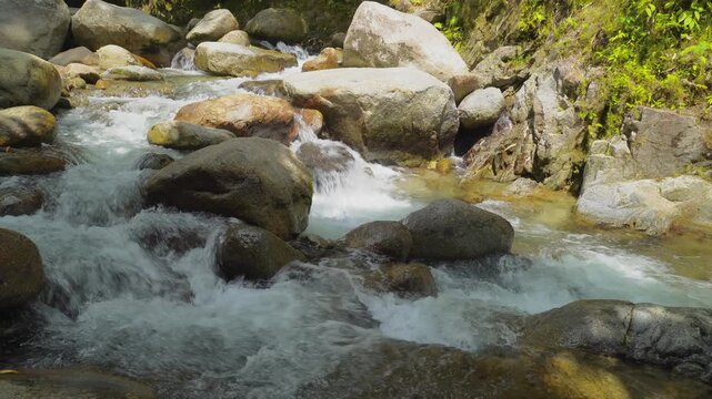 Small Waterfall Between Tropical River Rocks