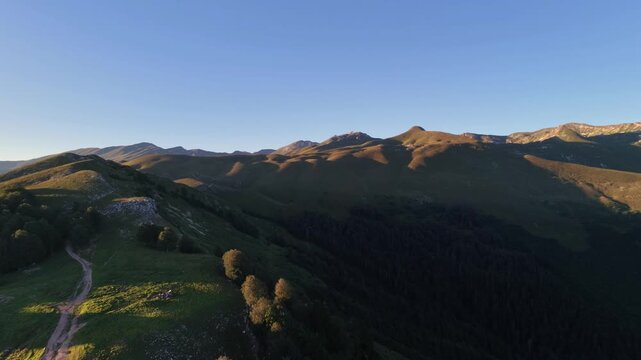 Majestic mountain ridges catching the warm light of golden hour sunset