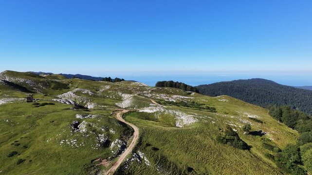 Winding mountain path overlooking the panoramic hills and natural landscape