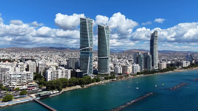 Aerial drone panoramic view of modern waterfront skyscrapers and Limassol city skyline along the Mediterranean Sea, Cyprus.	
