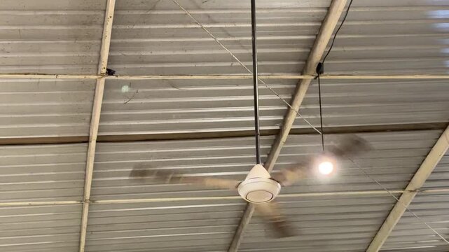 Rotating Ceiling Fan under Corrugated Metal Roof with Copy Space 4K