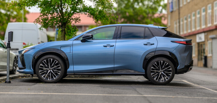 Gothenburg, Sweden - August 29 2026: Silver Lexus RZ electric SUV parked beside charging station.