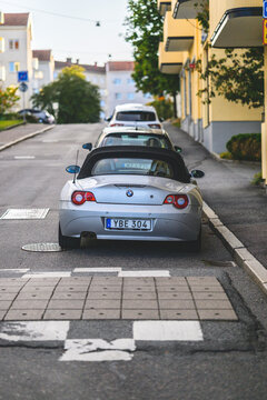 Gothenburg, Sweden - August 26 2026: Parked silver convertible car on narrow Swedish residential street.
