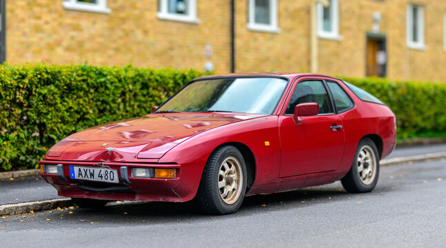 Gothenburg, Sweden - August 29 2026: Classic red Porsche 924 sports coupe parked on residential street.