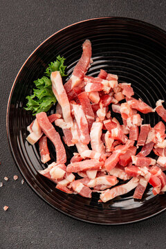 Bacon sliced into pieces pork meat lard serving size natural ingredients healthy eating wholesome dish, tasty snack fresh, gourmet, rustic food background on the table top view copy space
