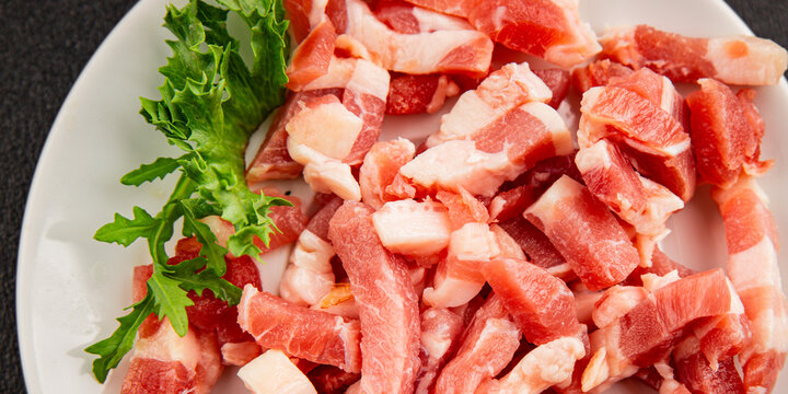 Bacon sliced into pieces pork meat lard serving size natural ingredients healthy eating wholesome dish, tasty snack fresh, gourmet, rustic food background on the table top view copy space
