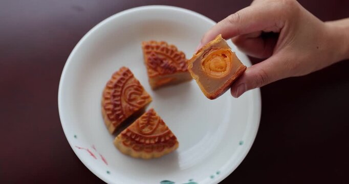 Traditional Chinese sweet dessert for celebrating the Chinese mid autumn festival.Chinese words mean: Two egg yolks white lotus seed paste mooncake.