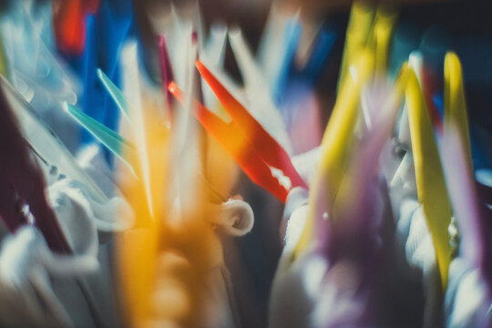 Close-up of colorful plastic clothespins on white fabric, with a soft blurred background. A vintage, everyday scene for laundry, home and lifestyle projects