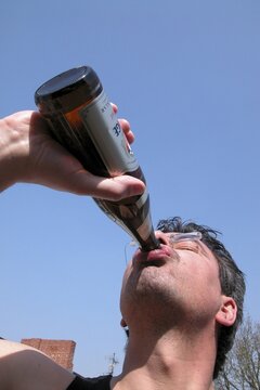 Man drinking beer out of a beer bottle
