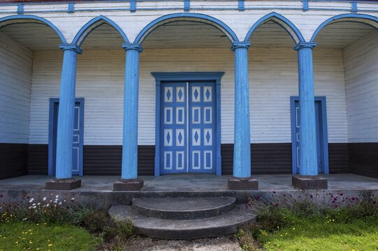 Blue painted entrance to the Unesco world heritage site, wooden church of Puchilco, Chiloe, Chile