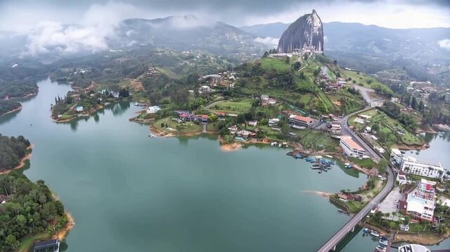 Guatap&eacute; with Piedra del Pe&ntilde;ol Rising above the Reservoir and Mountain Landscape in Antioquia, Colombia. Time Lapse. Establishing Shot. Aerial View.