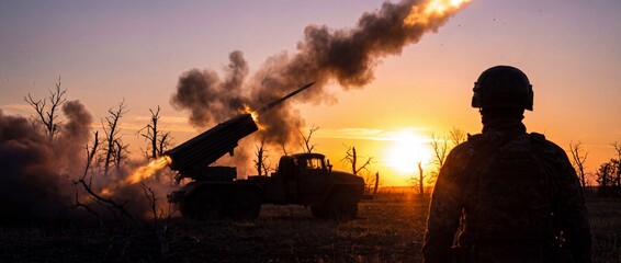 Fototapeta premium A soldier stands silhouetted against a dramatic sunset, witnessing the fiery launch of a rocket from a military vehicle amidst a desolate battlefield.