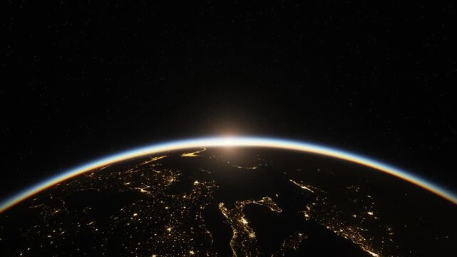 Sunrise over Earth from space, sun rising above glowing atmosphere as city lights fade into daylight
