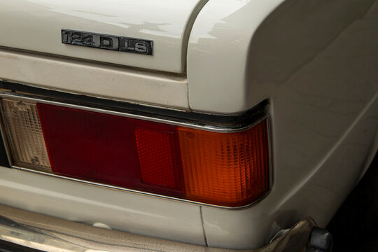 GANDIA,SPAIN - OCTOBER 4,2026 Detail of the rear taillight and model badge of a vintage white SEAT 124 D LS classic car.