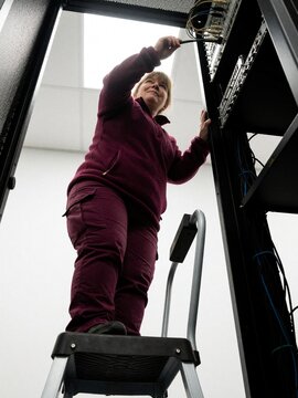 Woman Technician Working on Server Rack