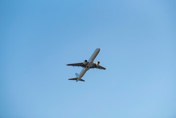 Fototapeta premium Big white passenger plane in blue sky