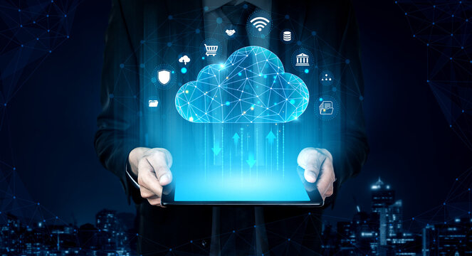 Businessman Holding Tablet with Cloud Technology Icons, Digital Network Connections, Data Management, and Abstract City Background at Night. Glyphic.