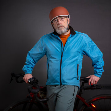 portrait of senior male cyclist wearing biking jacket and helmet