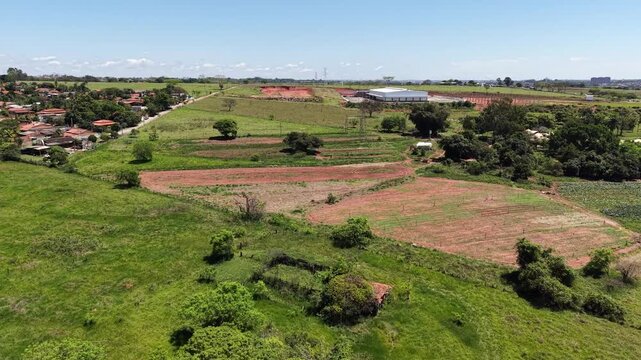 Aerial view of rural landscape with houses farms and fields showing agricultural development and urban sprawl