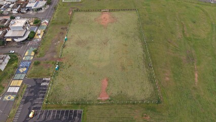 Aerial view of a neglected soccer field and colorful street art in a Brazilian neighborhood © Segati