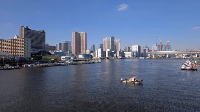 停泊するボートとビル群が見える港湾都市の風景。
