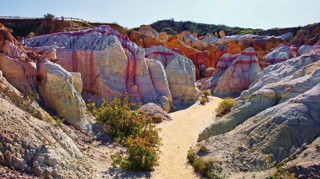 Vibrant pink and yellow geological formations rise at Paint Mines Interpretive Park in Calhan, Colorado