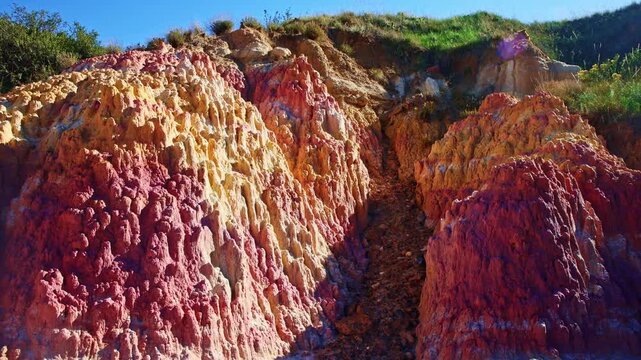 Vibrant pink and yellow geological formations rise at Paint Mines Interpretive Park in Calhan, Colorado