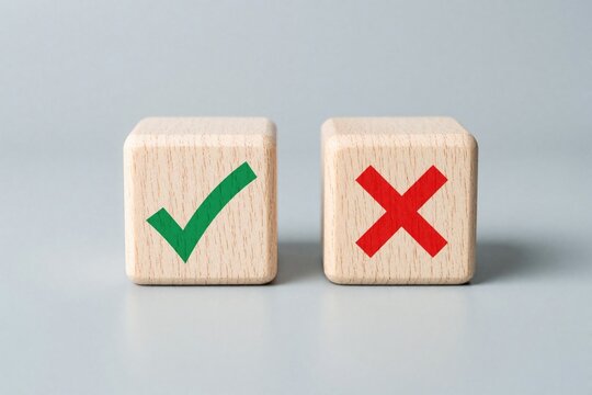 Wooden cube blocks with green check mark, red cross symbols on grey background. Minimal business concept for decision making, quality control, survey results. Represent approval, rejection, correct