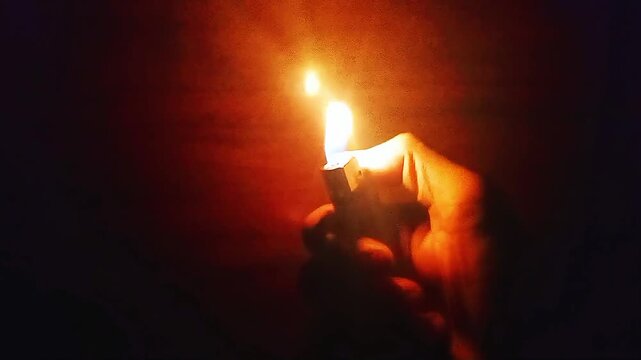 Close up of hands lighting a match