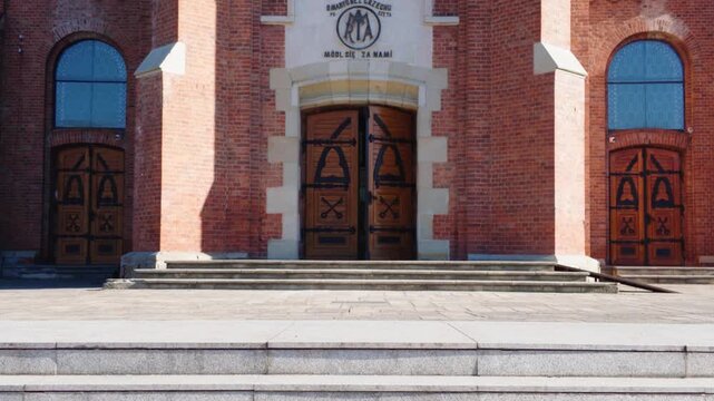 Front view of a historic brick church with architectural details in Cacica, Romania.