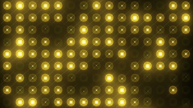 Flashing yellow led light wall with glowing golden bulbs on dark background for concert stage and entertainment show concept