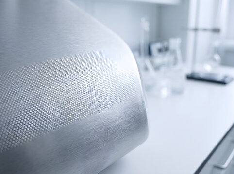 Close up shot of ada signage tactile braille panel inside a modern clean laboratory with science equipment