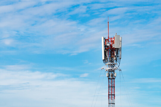 Telecommunication tower with cellular antennas against blue sky, wireless communication infrastructure for mobile network coverage, data transmission and modern digital connectivity.