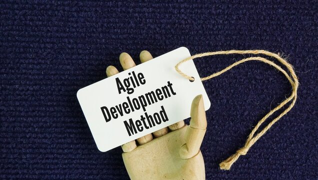 The paper tag bearing the words "Agile Development Method" refers to a flexible, phased, and iterative development approach, typically used for developing software, applications, or products.
