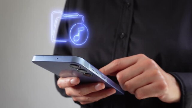Businesswoman holding a smartphone with a virtual icon of a music file folder.