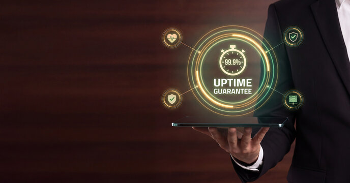 Businessman holding tablet with digital uptime guarantee interface