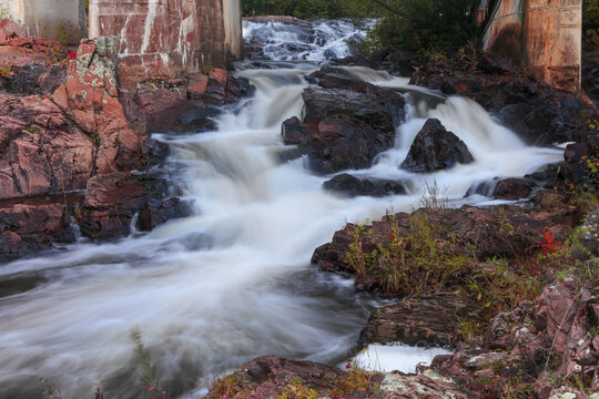 Water flowing over rocks in natural forest landscape in Michigan upper peninsula