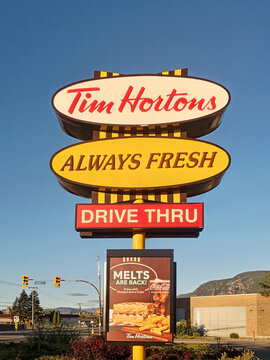 Penticton, Canada - June 21, 2026: Sign for Tim Hortons is displayed with menu board at a drive thru location in Penticton, British Columbia, Canada. It shows offers like melts and drinks.